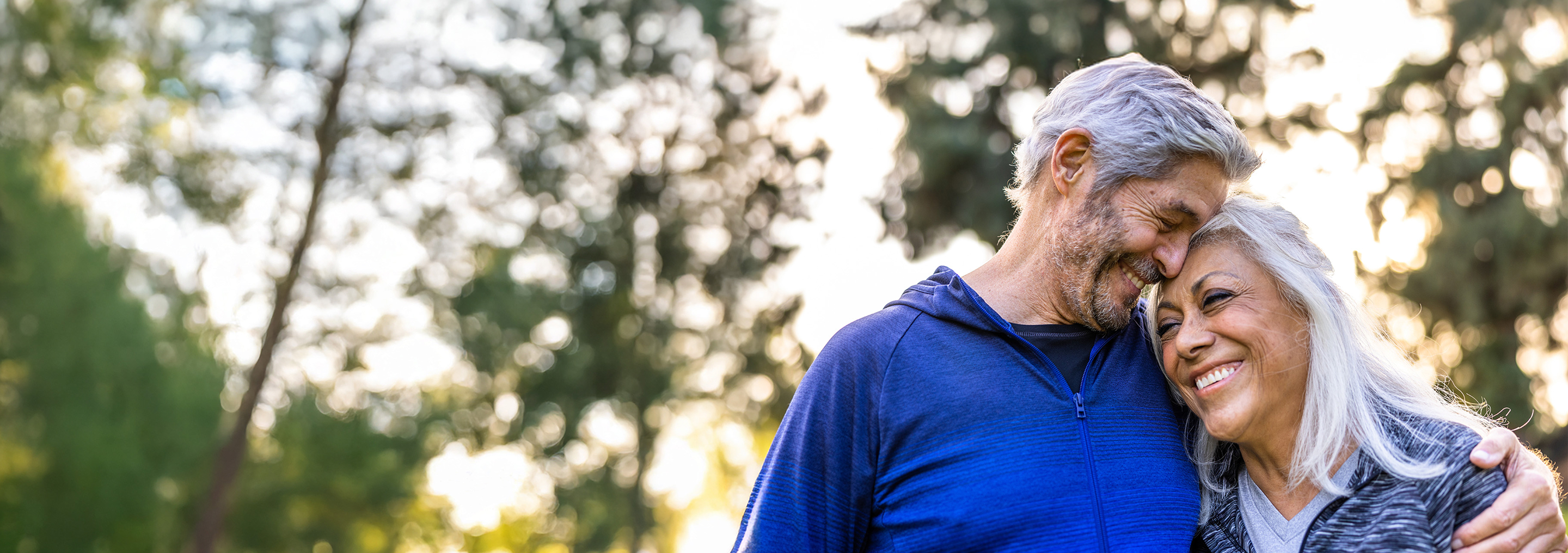 Couple in a warm embrace, smiling.